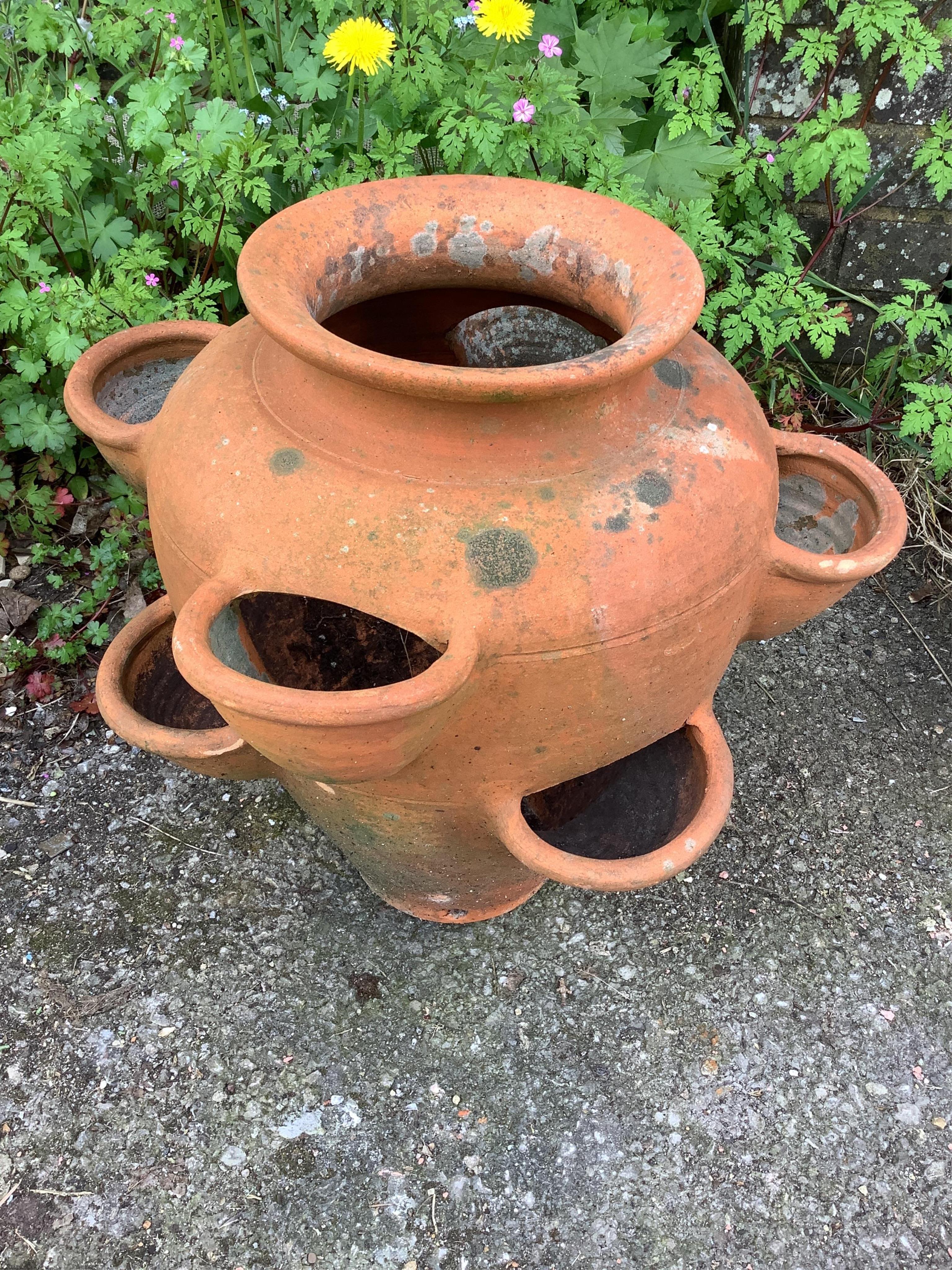 A terracotta strawberry planter and two other planters, largest height 39cm